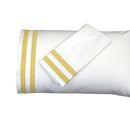 White pillowcases with gold stripes on a white background