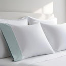 Pillow case with Sea color cuff displayed on a bed with white bedding
