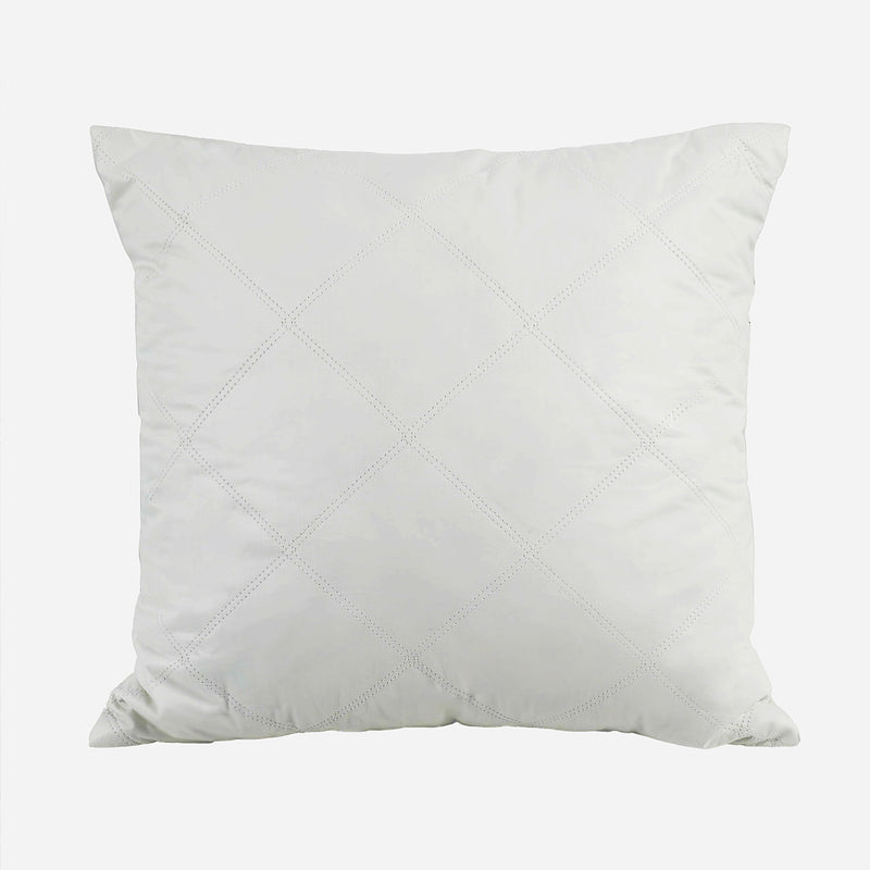 White pillow with a diamond pattern on a light gray background